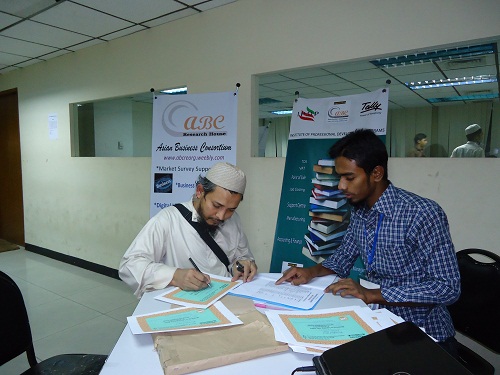 Signing participant certificates for Learning Tally ERP 9 workshop at ASA University Bangladesh